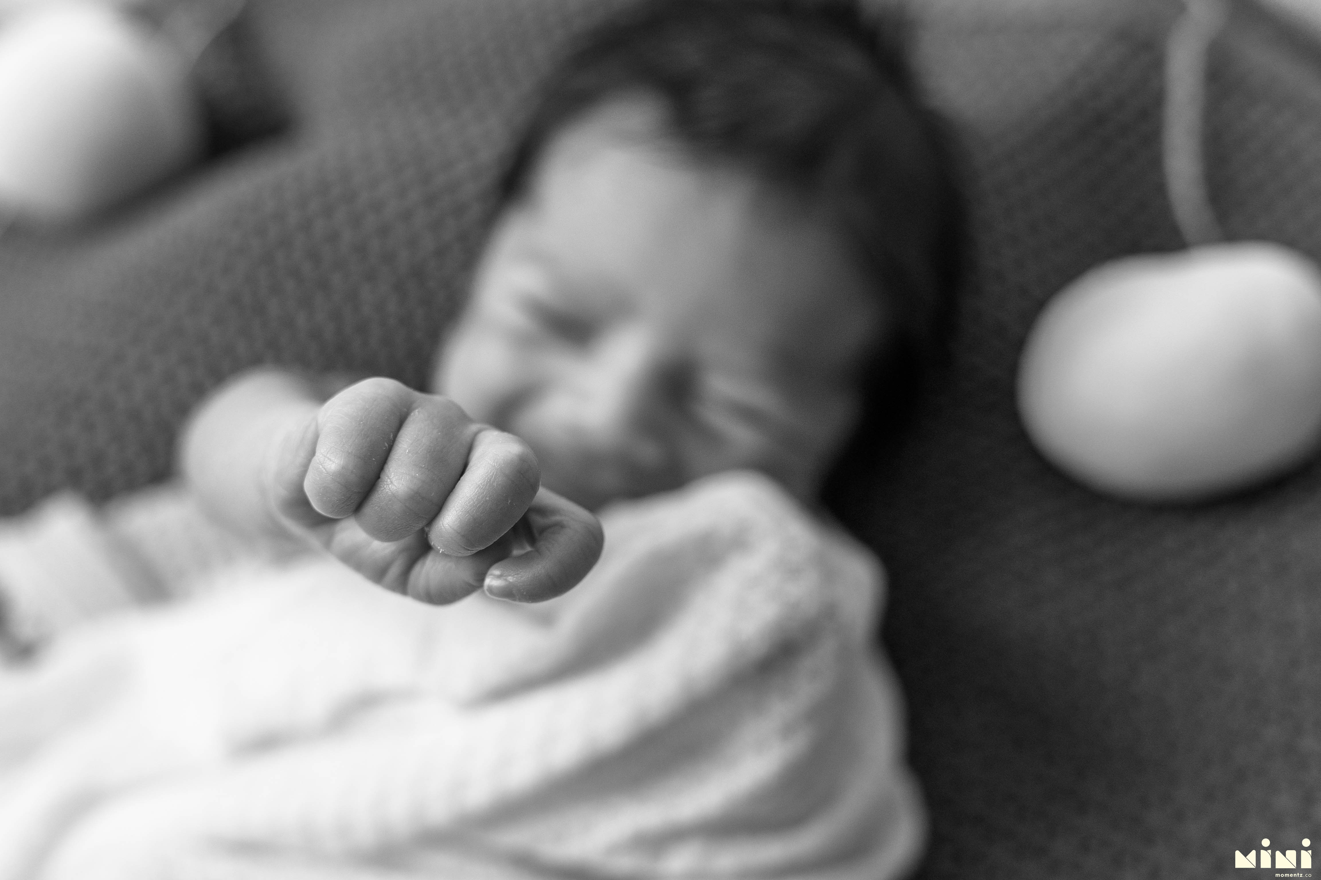 Close-up of a newborn baby's tiny clenched fist — detail photograph from the MiniMomentz Edinburgh newborn session