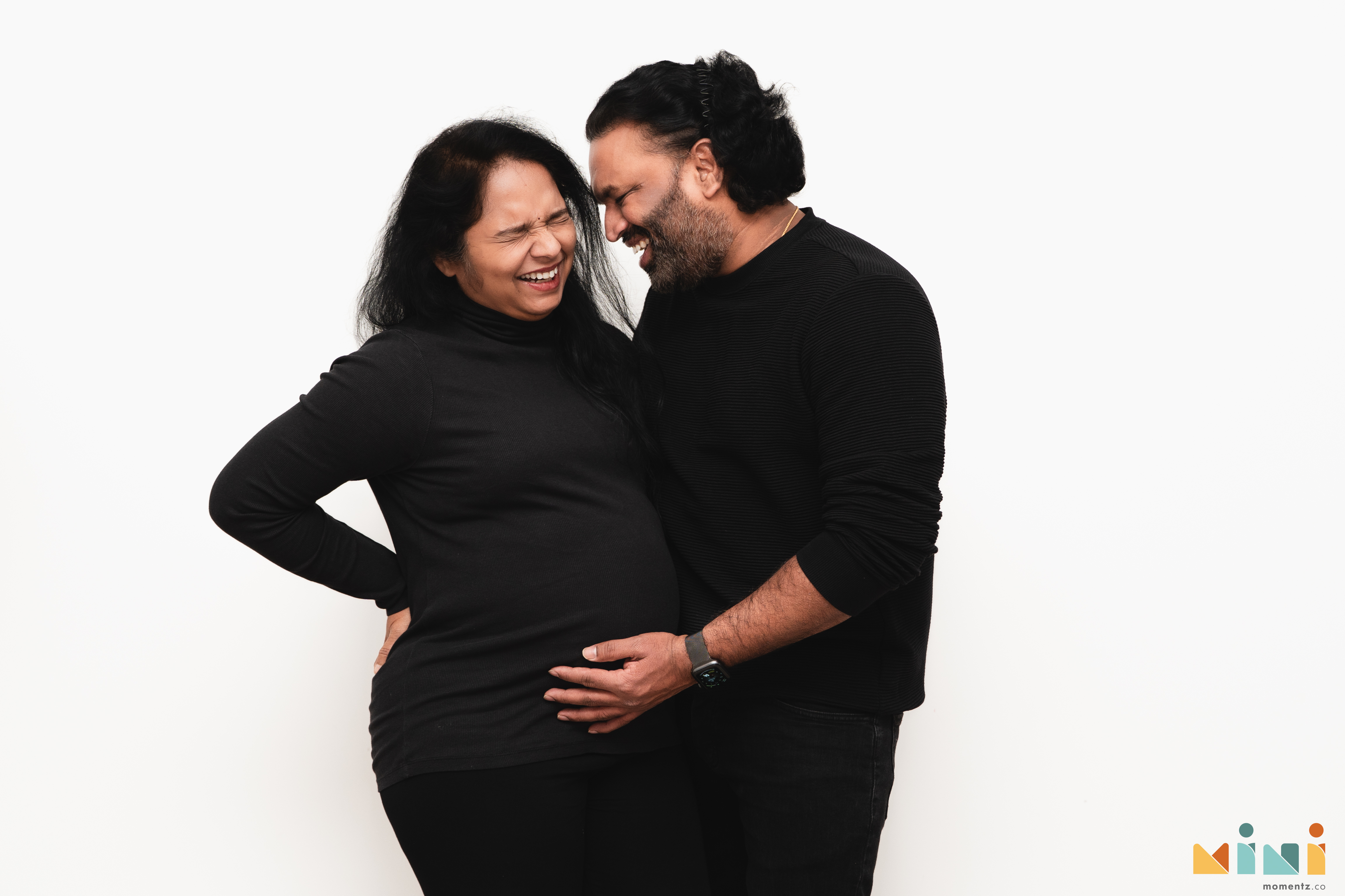 Chaithanya and Sowjanya laughing together during their maternity photography session in East Calder, Scotland — the unplanned moments that define a session