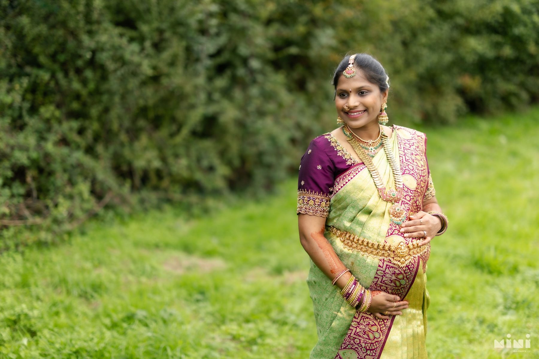Divya smiling during her maternity portrait session before the Seemantham
