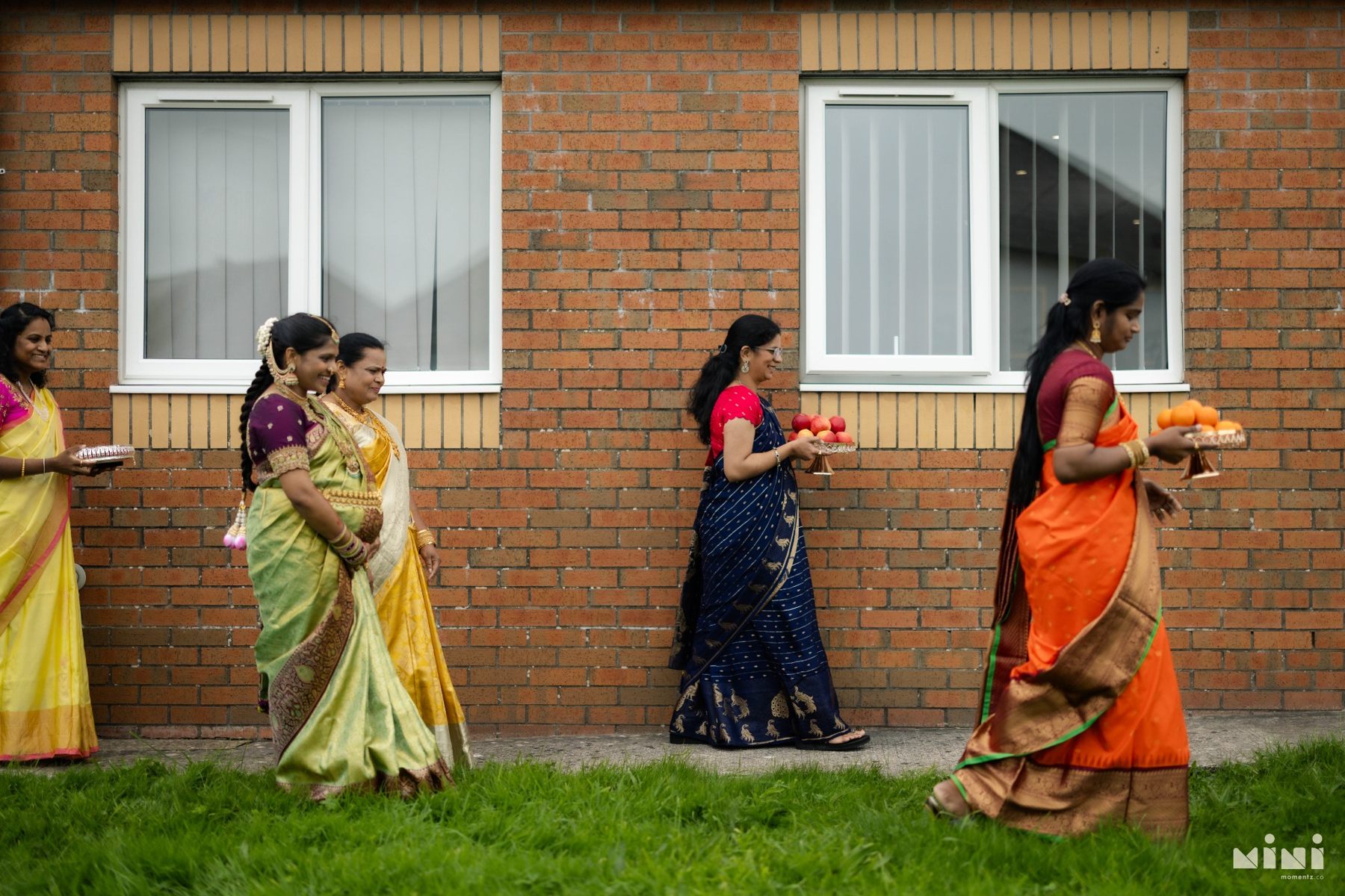 Family members carrying fruit offerings for Divya’s Seemantham celebration