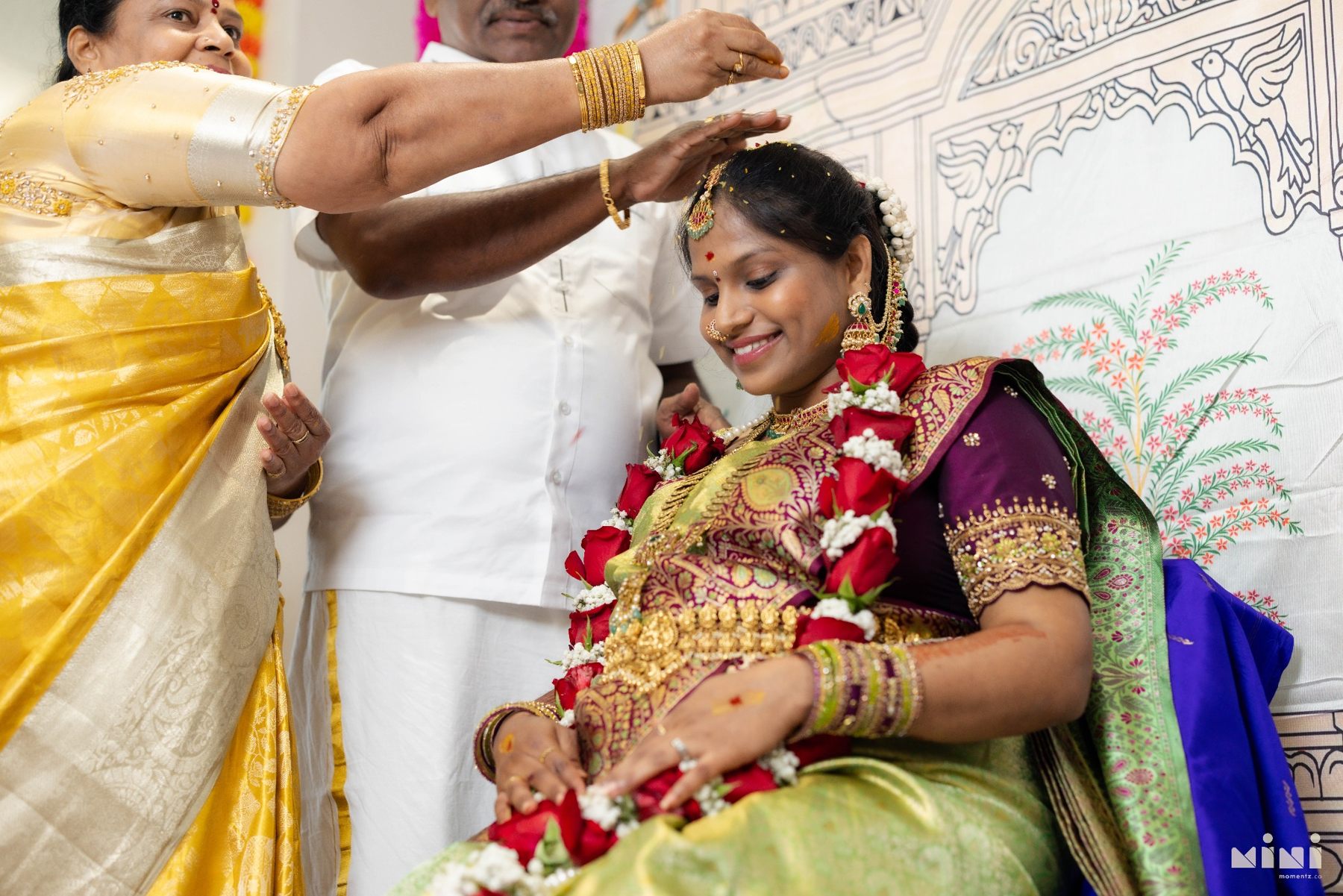 Divya receiving a traditional blessing from her parents during Seemantham