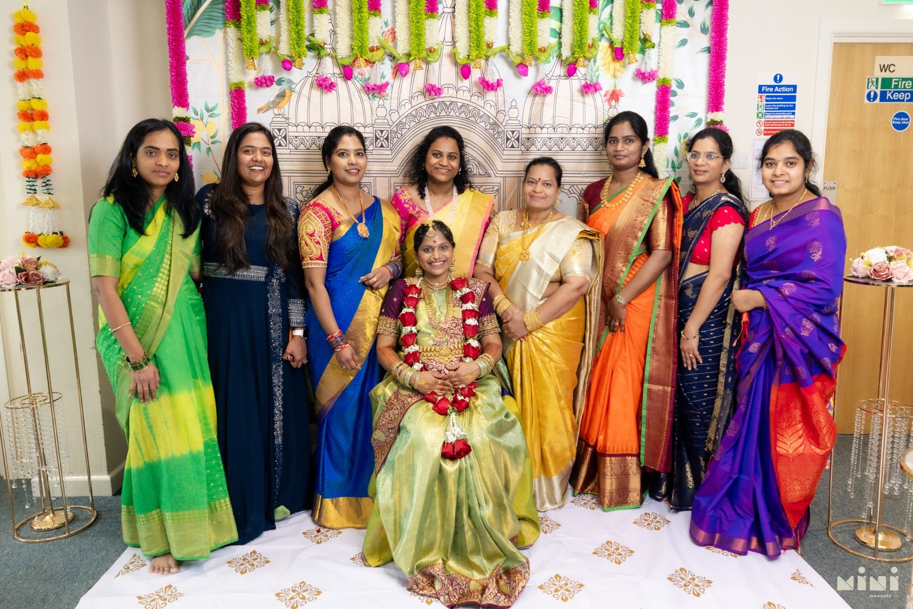 Divya surrounded by friends and family in colourful sarees at the Seemantham
