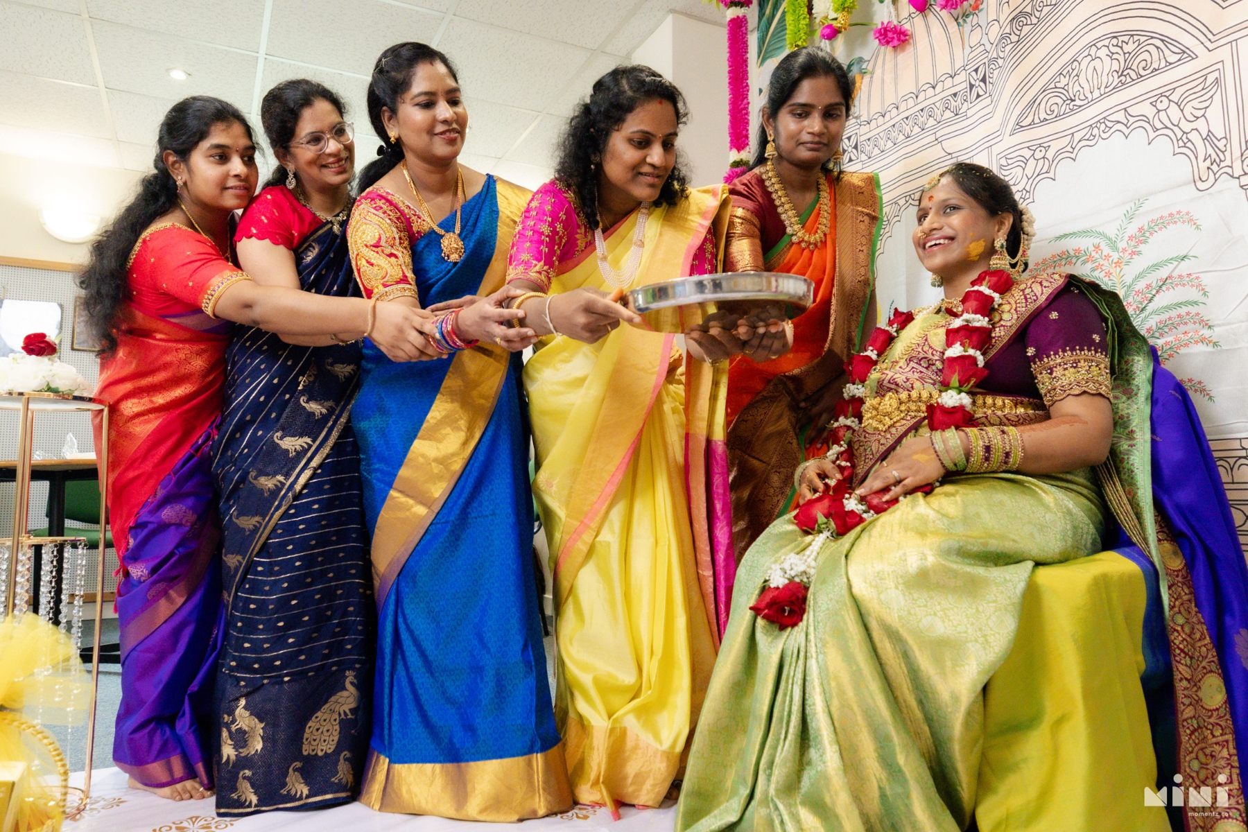 Divya smiling as family members gather around her during her Seemantham blessings
