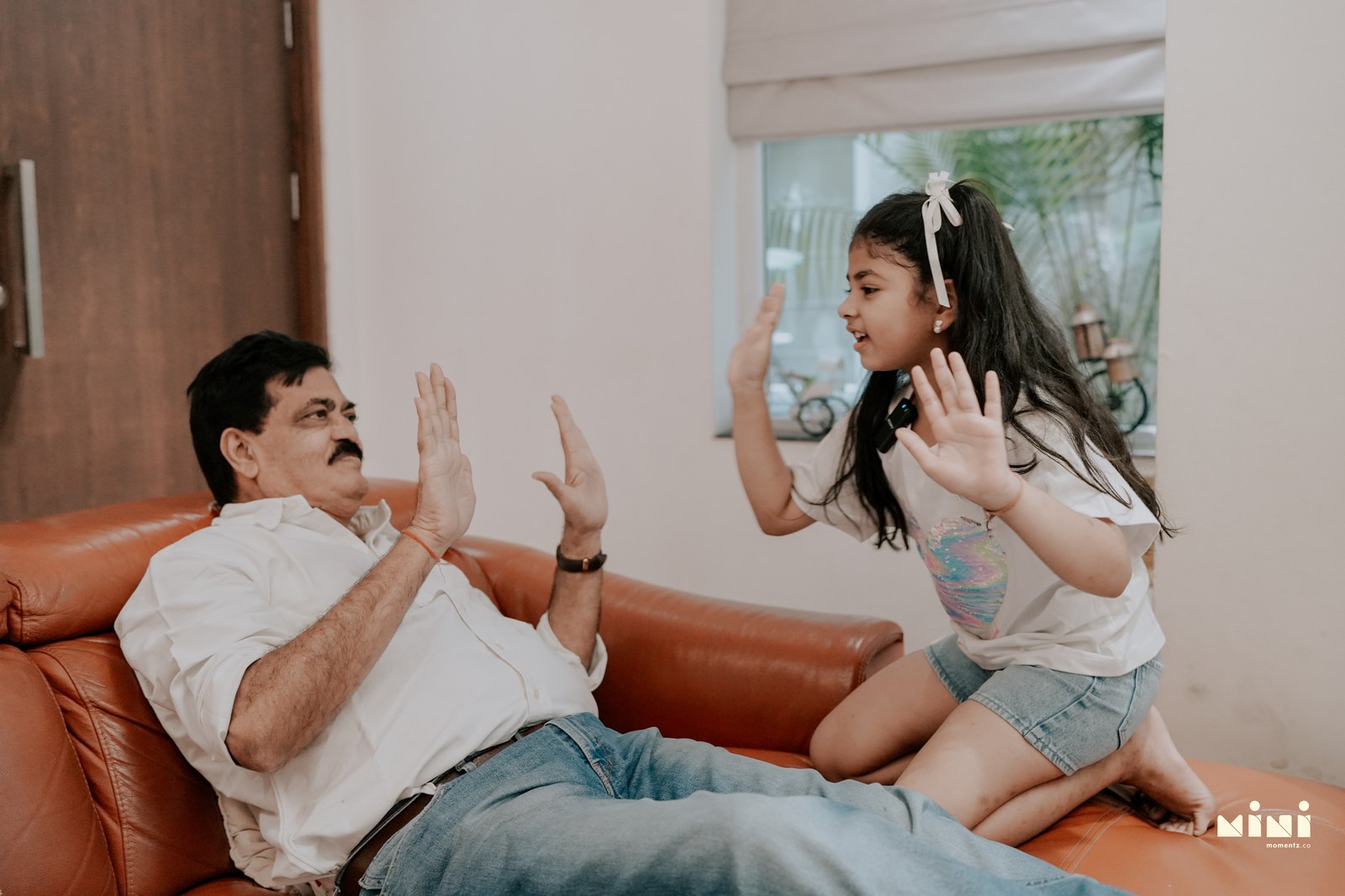 Grandfather and granddaughter playing — three generations family photography UK MiniMomentz