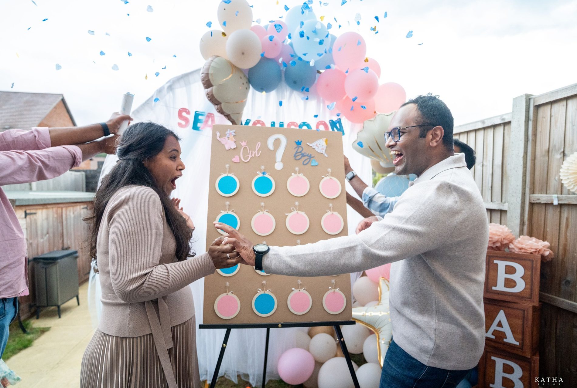 Sravanthi and Akhil celebrate their baby boy with blue confetti during their gender reveal in Ebbsfleet, Kent