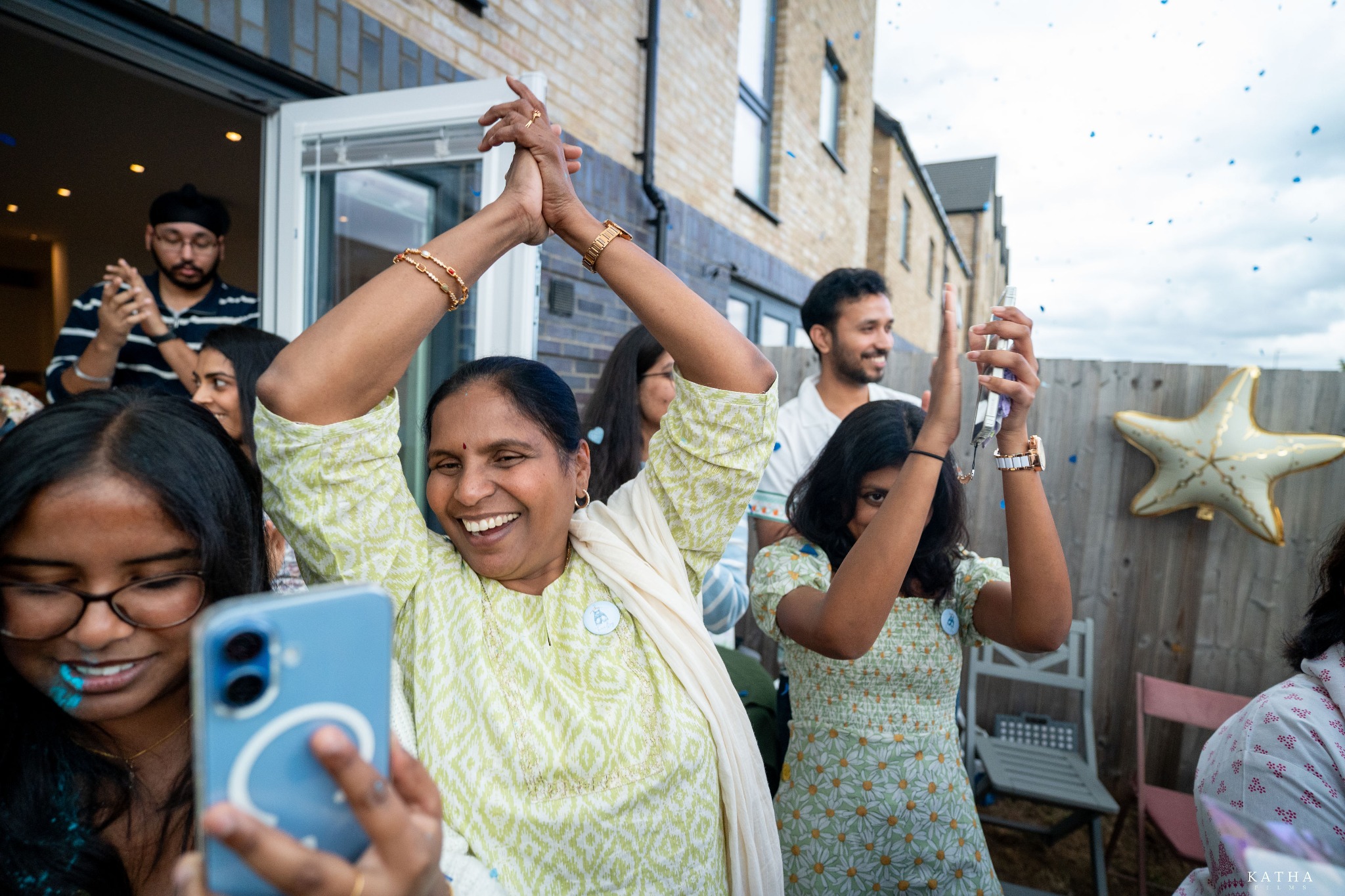 Friends join Sravanthi and Akhil for the blue-confetti celebration in Ebbsfleet, Kent